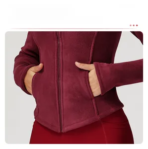 Detailed view of women's burgundy fleece jacket with side pockets and zip closure
