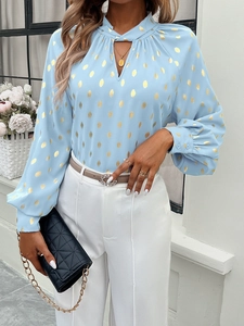 Detailed view of women long sleeve sky blue chiffon shirt featuring gold polka dot patterns