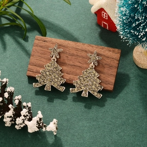 Elegant Christmas tree earrings with sparkling rhinestones on rustic wooden decor