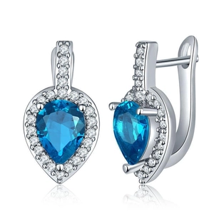 Detail of pear-cut blue zircon drop earrings with shimmering white halo on white base