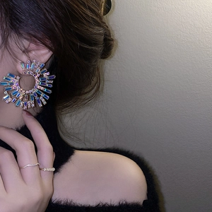 Detailed view of fashion earrings featuring colorful rhinestones in a radial design