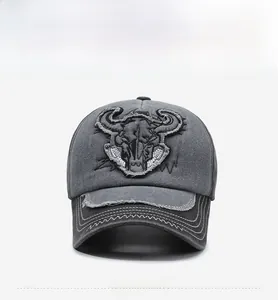Detailed embroidery of a bull skull on a two-tone vintage washed denim baseball cap