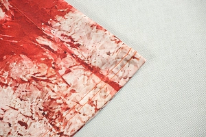 Macro detail of red marble print fabric with high-density double-needle stitching quality