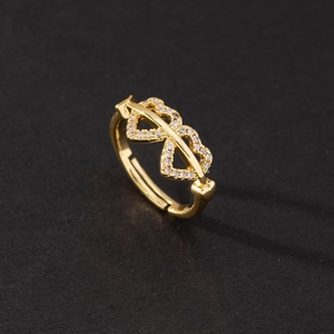 Macro shot of gold adjustable ring with sparkling micro-paved cubic zirconia hearts
