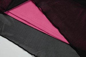 Detail of multi-layered red mesh fabric with fine lettuce edge stitching and dual seams