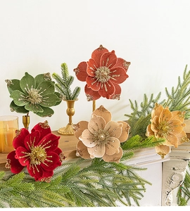 Detailed view of velvet poinsettia flowers with glitter edges on a festive mantel