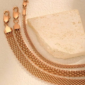 Detail of rose gold mesh bracelets in various widths with woven texture and lobster clasps