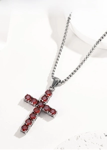 Detailed macro view of high-quality titanium steel cross pendant with deep red zircons