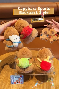 Close-up of brown capybara plush keychain wearing a colorful miniature sports backpack