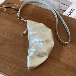 Gros plan sur le mini sac argenté en forme de croissant avec texture métallique
