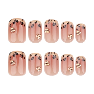 French leopard print press-on nails with nude gradient base and 3D gold accents