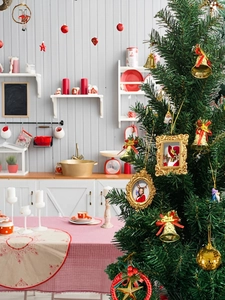Macro shot of festive Christmas tree ornaments with golden picture frame and bells