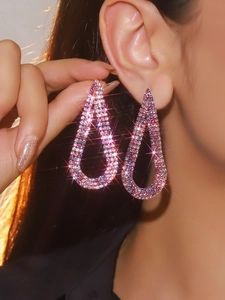Detailed close-up of luxury fuchsia rhinestone water drop tassel earrings with shimmering crystals