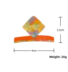 Detailed view of large acetate claw clip with colorful floral pattern and dimensions
