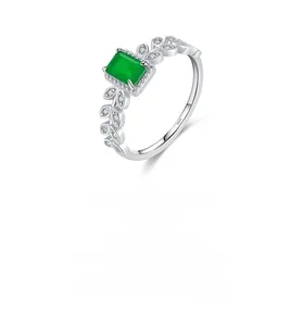 Detailed macro view of S925 silver ring featuring a green zircon and leaf diamond accents