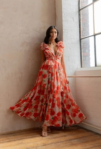 Detailed view of floral maxi dress with deep V-neck and ruffled shoulder flower decorations