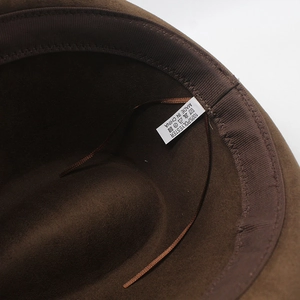 Détail d'un chapeau en suédine avec bandeau interne, cordon réglable et étiquette de matière