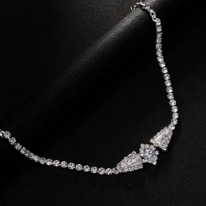Elegant silver necklace with geometric rhinestone pendants on a premium black velvet surface