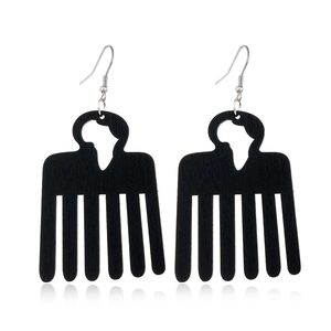 Detail of black wooden afro comb earrings with cutout African map on white background