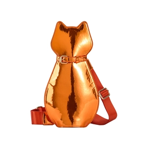 Detailed view of cat-shaped metallic orange patent leather bag with red shoulder strap
