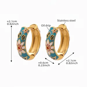 Detail view of gold-plated stainless steel hoop earrings with colorful floral enamel