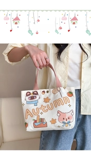 Close-up of autumn-themed canvas tote bag featuring cute cat and fox illustrations