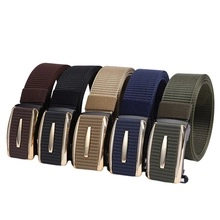 Close-up of five colorful nylon belts with metal buckles in black, brown and navy