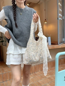 Floral canvas tote bag with lace ribbon shown in a trendy cafe lifestyle street shot