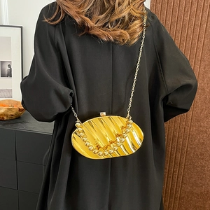 Golden leaf-shaped acrylic evening bag with ripple texture and elegant pearl chain strap