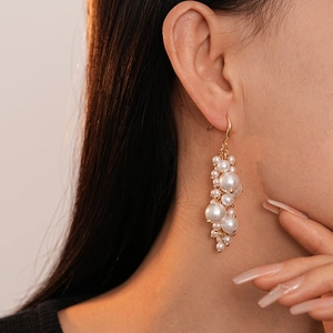 Baroque pearl tassel earrings with gold hooks shown on a model for a vintage French look