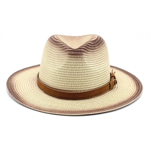 Detail of woven straw fedora with brown gradient edges and a faux leather band