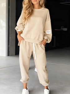 Detail of knitted lounge set featuring ribbed cuffs and elastic drawstring waistband