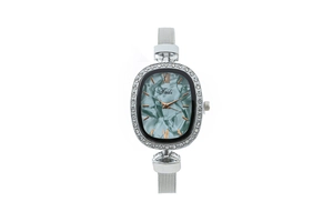 Close-up of elegant women's oval watch with textured dial and silver mesh strap