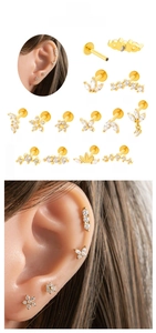 Detailed set of twelve gold stainless steel labret studs with zircon flower and butterfly designs