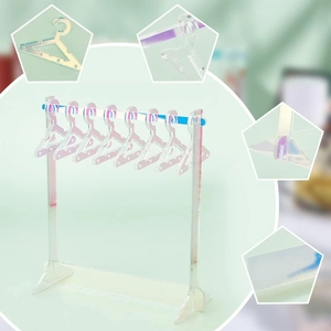 Close-up of clear acrylic jewelry stand with 8 hangers for earrings and doll clothes
