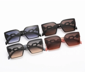 Detail showing oversized square sunglasses in four gradient colors with hollow chain temples