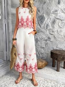 Detailed embroidery on white two-piece sleeveless top and wide-leg vacation set