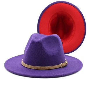 Detail of wool fedora hat with purple exterior, red lining, and leather belt with gold buckle