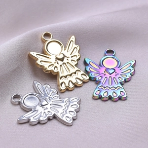 Three angel wing pendants with heart cutouts in gold silver and rainbow plating on silk
