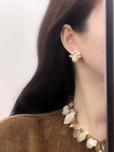 Vue détaillée des boucles d'oreilles fleur plaquées or 18k avec perles et cristaux