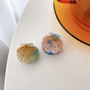 Set of two small shell-shaped acetate hair claws in pastel green and pink blue colors
