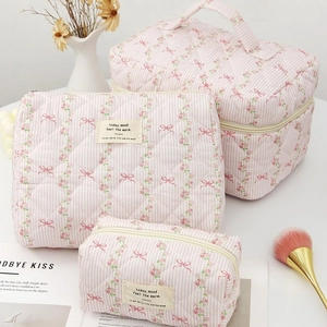 Three-piece floral quilted makeup bag set with stripes and portable carry handle