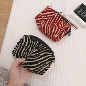 Detail of zebra pattern fabric makeup pouches with premium jacquard texture and zip closure