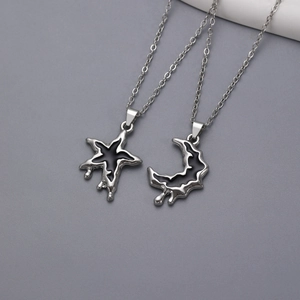 Detailed shot of irregular lava silver and black starfish and moon pendant necklaces