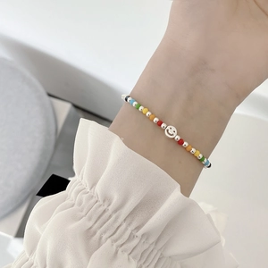 Rainbow beaded S925 sterling silver smiley face charm stretch bracelet on wrist