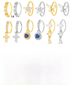 Detail of 8mm copper nose rings with butterfly and flower zircon inlay in gold and silver