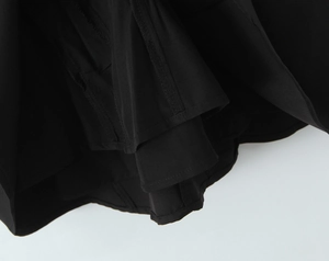 Nahaufnahme des schwarzen gestuften Rüschensaums mit präzisen Nähten am Vintage-Kleid