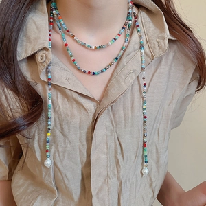 Detail of colorful crystal beads and white pearls on a bohemian multi-use necklace