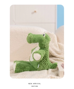Close-up of cute green plush crocodile doll with soft fluffy texture and neat stitching