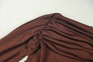 Close-up of ruched stitching details on dark brown sleeveless bodysuit fabric